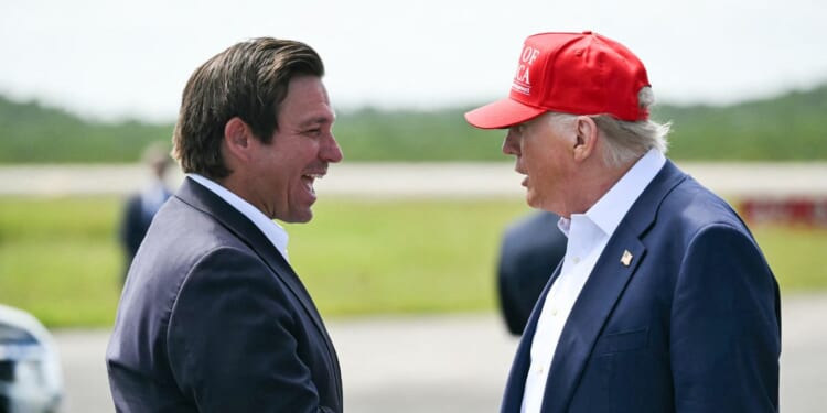 Florida Gov. Ron DeSantis shakes hands with President Donald Trump upon Trump's arrival at Dade-Collier Training and Transition Airport in Ochopee, Florida, on July 1, 2025.