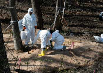 Workers prepare to take soil samples where raw sewage flowed near the Potomac River in Cabin John, Maryland, on March 14, 2026.