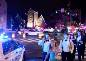 Guests walk away from the Washington Hilton amid a heavy police presence after shots were heard during the White House Correspondents' Dinner in Washington, D.C., on April 25, 2026.