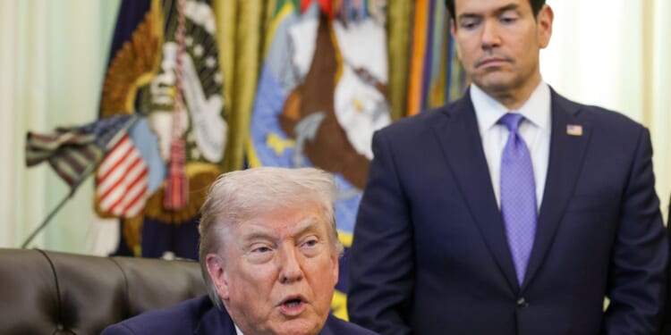 President Donald Trump speaks as Secretary of State Marco Rubio looks on during a meeting in the Oval Office of the White House on April 23, 2026, in Washington, D.C.