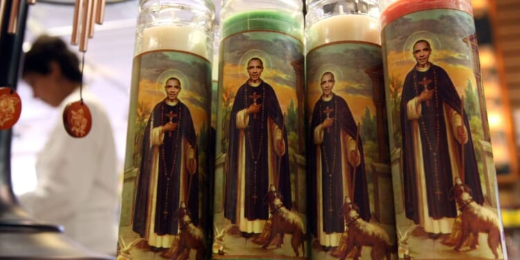 Candles depicting former President Barack Obama as a saint stand displayed at "Just For Fun" in San Francisco, California, on March 2, 2009.