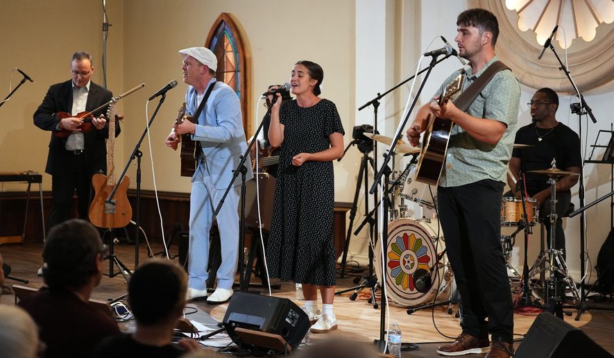 Conrad Fisher, Rose Stoltzfus and Ben Stoltzfus perform at Ragamuffin Hall in McCoysville, Pa., Saturday, April 25, 2026. (AP Photo/Matt Rourke)