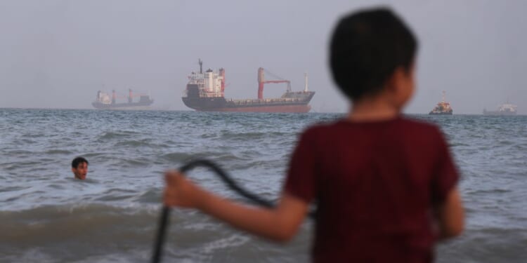 Ship hit by projectiles in Strait of Hormuz, British military says