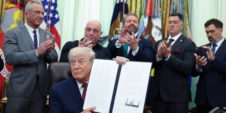 President Donald Trump shows his signature in the Oval Office after signing an executive order April 18 directing the Food and Drug Administration to issue new guidance on the use of psychedelic drugs intended for clinical trials for U.S. veterans suffering from Post Traumatic Stress Disorder.