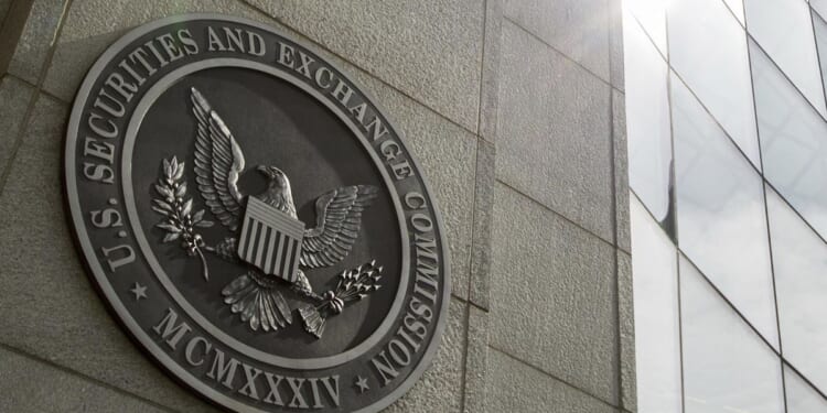 SEC, DOJ charge 21 in scheme that netted millions in illicit trading profits