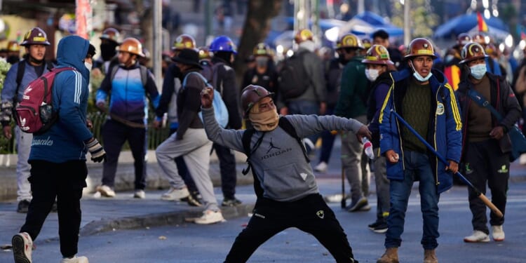 Clashes erupt in Bolivia as miners set off dynamite and police fire tear gas