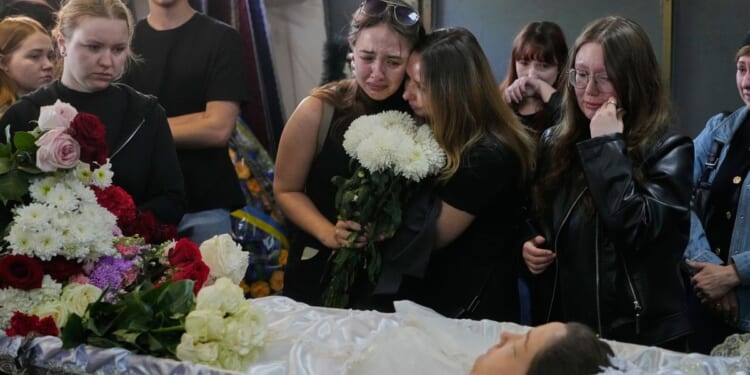Young Kyiv couple killed in a fierce Russian airstrike hoped to start a family, mourners say