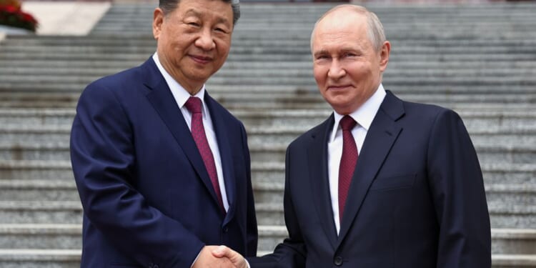 Putin and Xi hail their high-level ties and growing energy trade as they meet in Beijing