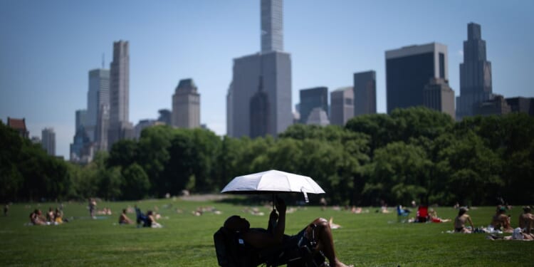 Eastern U.S. sweats through another hot day before rain, cold move in