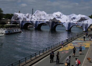 Artist JR, the ‘French Banksy,’ creates a ‘cave’ installation over Paris’ oldest bridge