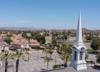 An aerial view of a sprawling single family home neighborhood and church in Menifee, California.