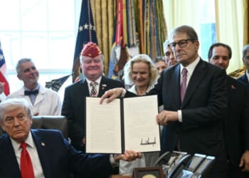 President Donald Trump and Howard Kessler, founder of the Commonwealth Project, hold up an executive order easing restrictions on marijuana in the Oval Office at the White House in Washington, D.C., on Dec. 18, 2025.