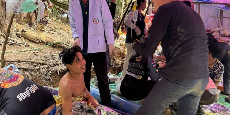 Rescuers free 4 men who had been trapped in a flooded Laos cave, search for 2 still missing