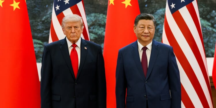 Donald Trump and Xi Jinping standing in front of flags