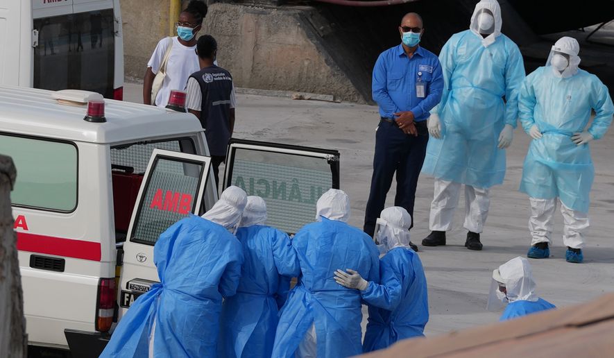 Health workers in protective gear evacuate patients from the MV Hondius cruise ship into an ambulance at a port in Praia, Cape Verde, Wednesday, May 6, 2026. (AP Photo/Misper Apawu)