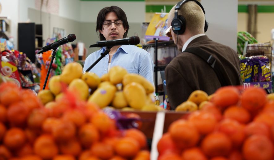 Luna Luna band members Kevin Gonzalez and Caleb Powers perform in the produce section of Fiesta Fresh Market in New Castle, Del., on Sunday, April 26, 2026. (AP Photo/Mingson Lau)