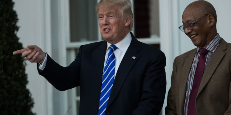 Donald Trump shares a laugh with civil rights icon Bob Woodson.