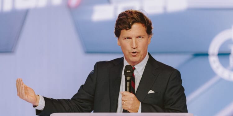 Conservative political commentator and podcast host Tucker Carlson speaks at Turning Point USA's annual AmericaFest conference, in remembrance of late political activist Charlie Kirk, in Phoenix, Arizona, on Dec. 18, 2025.