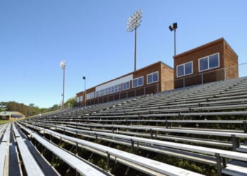 Stadium seats at an outdoor track.