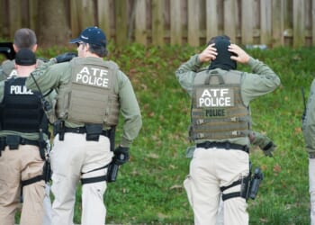 Authorities from the Bureau of Alcohol, Tobacco, Firearms, and Explosives prepare to search a home in Hyattsville, Maryland, on Nov. 8, 2011.
