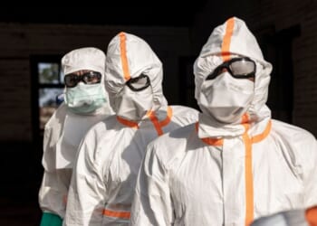 Workers line up to disinfect their protective equipment at General Referral Hospital of Mongbwalu during the Ebola outbreak response in Mongbwalu, Ituri province, eastern Democratic Republic of Congo, on May 20, 2026.