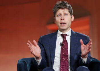 OpenAI CEO Sam Altman speaking while seated