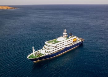 This aerial picture shows a general view of the cruise ship MV Hondius stationary off the port of Praia, the capital of Cape Verde, on May 3, 2026.