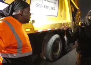 A truck driver gives a masked protester an earful after traffic was halted,
