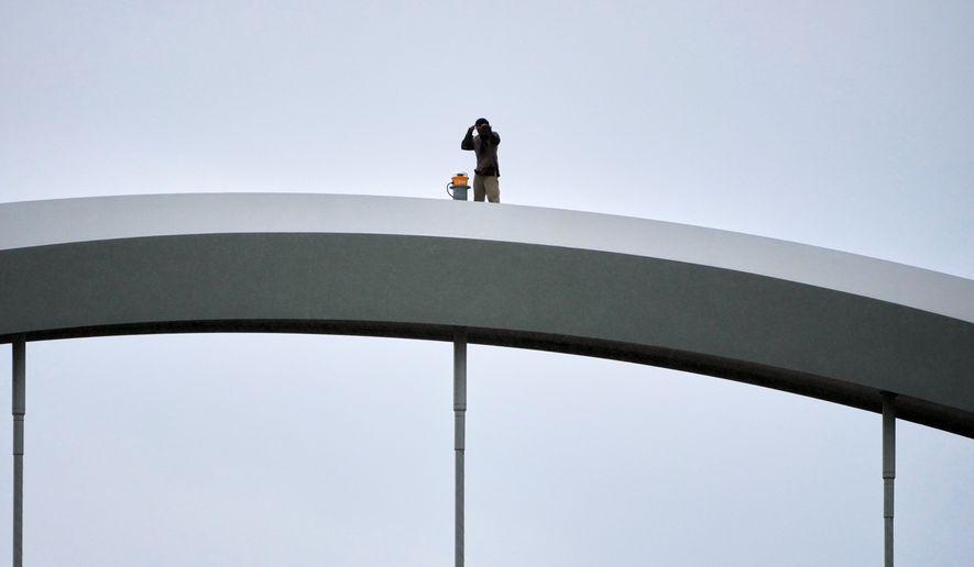 Guido Reichstadter, 45, is seen on top of the Frederick Douglass Bridge, Wednesday, May 6, 2026 in Washington. (AP Photo/Julia Demaree-Nikhinson)