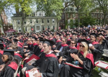 Harvard Business School graduates seated outdoors