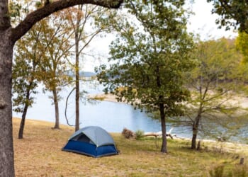 Camping tents near a beautiful lake among trees at Broken Bow Lake in Oklahoma.