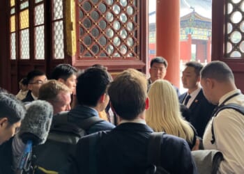 Members of the White House press pool are held by security members in a side room during President Donald Trump's visit to Temple of Heaven Thursday in Beijing, China. As an effort by Chinese officials to keep a tight hold of their American guests and dictate coverage of a global news event, U.S. reporters have been subject to strict controls.