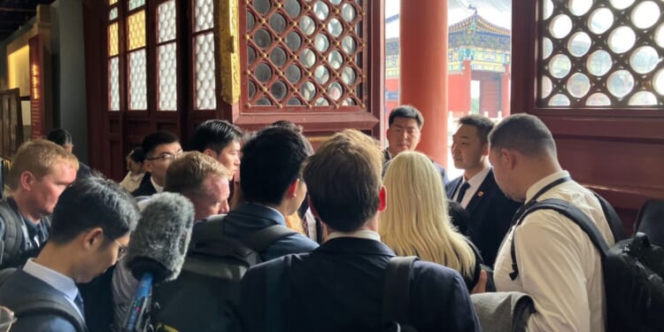 Members of the White House press pool are held by security members in a side room during President Donald Trump's visit to Temple of Heaven Thursday in Beijing, China. As an effort by Chinese officials to keep a tight hold of their American guests and dictate coverage of a global news event, U.S. reporters have been subject to strict controls.