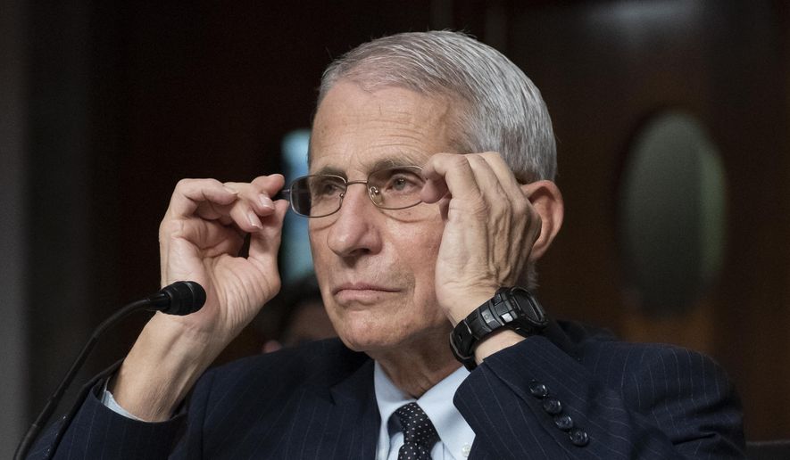 Dr. Anthony Fauci, then-director of the National Institute of Allergy and Infectious Diseases, adjusts his glasses during a Senate Health, Education, Labor, and Pensions Committee hearing on Capitol Hill, Nov. 4, 2021, in Washington. (AP Photo/Alex Brandon, File)