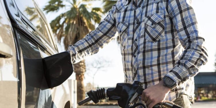 A man pumps gas.