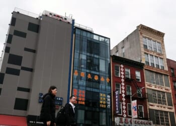 People walk by a building suspected of being used as a secret police station in Chinatown for the purpose of repressing dissidents living in the United States on behalf of the Chinese government in lower Manhattan on April 18, 2023, in New York City.