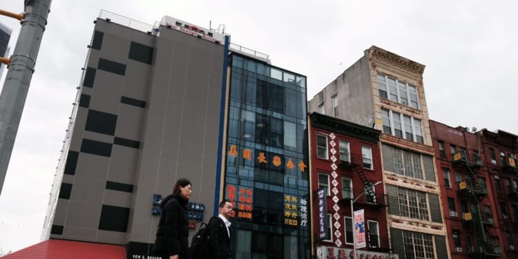 People walk by a building suspected of being used as a secret police station in Chinatown for the purpose of repressing dissidents living in the United States on behalf of the Chinese government in lower Manhattan on April 18, 2023, in New York City.