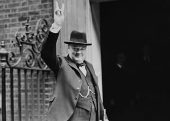 Winston Churchill holding up his hand in a "V" sign