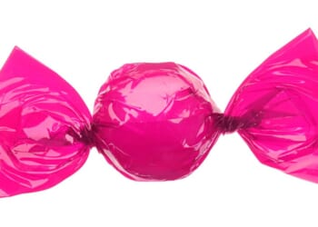 A candy wrapped in a pink wrapper.