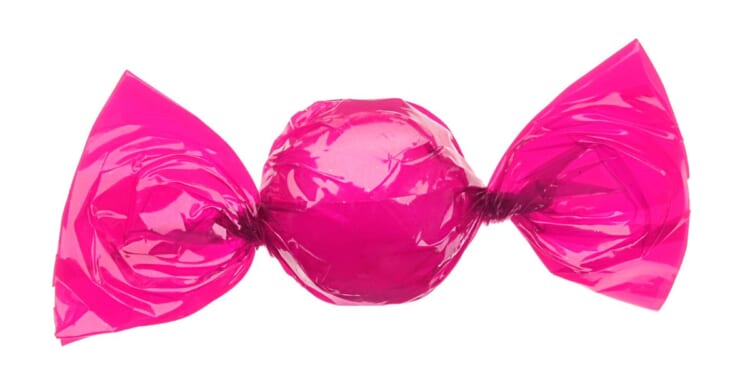 A candy wrapped in a pink wrapper.
