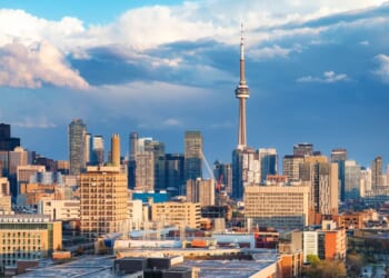 The Toronto financial district and Spadina avenue skyline on a partially cloudy springtime evening after a rain storm.