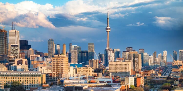 The Toronto financial district and Spadina avenue skyline on a partially cloudy springtime evening after a rain storm.