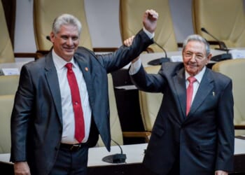 Former Cuban President Raul Castro raises the hand of current President Miguel Diaz-Canel