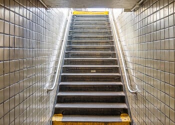 Stairs leading up to the street from an underground subway station in New York City.