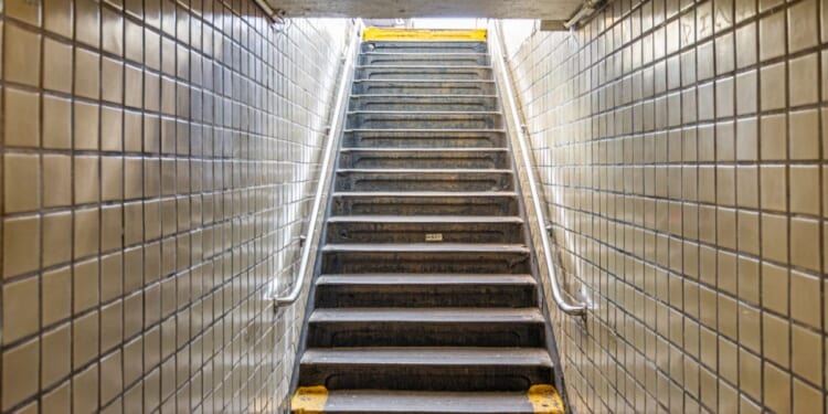 Stairs leading up to the street from an underground subway station in New York City.