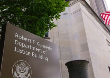 A sign is displayed outside of the Robert F. Kennedy U.S. Department of Justice building in June 2025 in Washington, D.C.