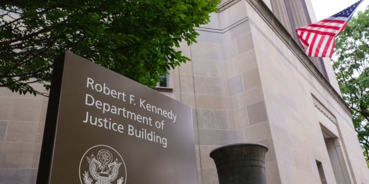 A sign is displayed outside of the Robert F. Kennedy U.S. Department of Justice building in June 2025 in Washington, D.C.