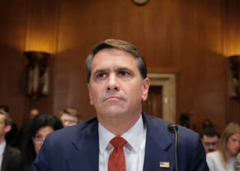 Acting U.S. Attorney General Todd Blanche seated
