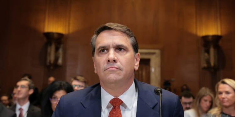 Acting U.S. Attorney General Todd Blanche seated