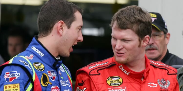 Driver Kyle Busch talks to driver Dale Earnhardt Jr. in the garage during NASCAR testing at Las Vegas Motor Speedway on Jan. 30, 2007 in Las Vegas.